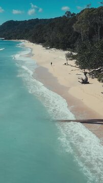 Serene coastal view.Peaceful beach scene featuring smooth waves and bright turquoise waters.Tranquil seaside landscape showcasing gentle shimmering aquamarine waters, Alas Purwo, National Park