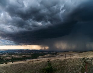 Fototapeta premium dark stormy heavens looming over a broad landscape delivering heavy precipitation