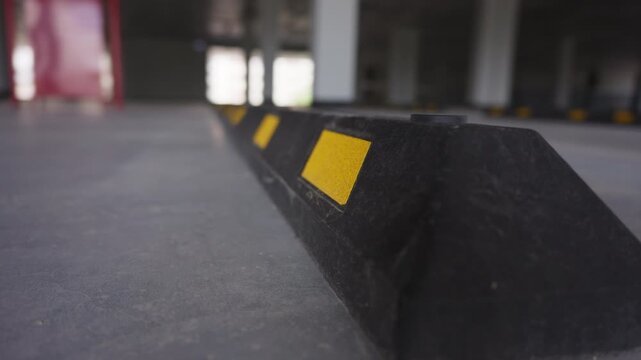 Parking wheel stop in covered parking garage