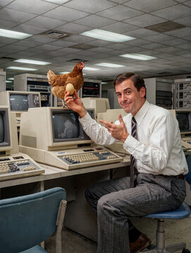 Businessmen pointing at an egg in old computer lab