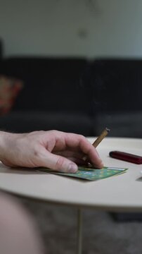 Vertical screen Smoldering cigarette beside lottery scratch ticket highlights gambling addiction nicotine dependence risky habits hope for quick money financial stress and chance