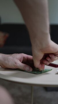 Vertical screen Two people scratching lottery ticket together with coin sharing excitement hope teamwork anticipation of winning cash prize lucky moment and instant game