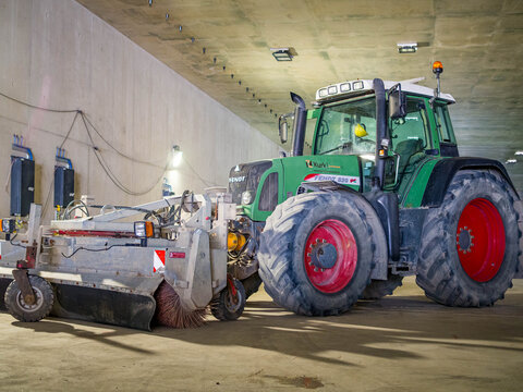 Fendt tractor with road sweeper parked under concrete bridge at deepened A9 Amsterdam ring road construction site for cleaning and urban site maintenance, 25 June 2026, Amstelveen, The Netherlands