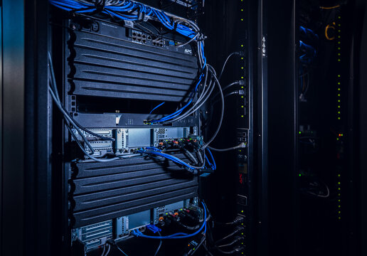 View of a server rack with networking equipment and blue cables in a data center in Los Angeles, California, United States.