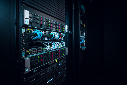 View of a server rack with network switches and blue ethernet cables in a data center in Los Angeles, California, United States.
