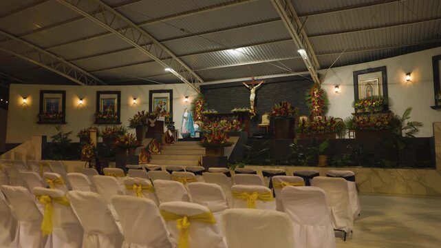 Queretaro Event Hall With White Chairs And Floral Display 