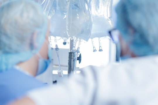 Medical Operation Scene with Healthcare Professionals and IV Drips