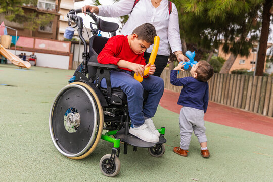 Child with cerebral palsy playing with balloon