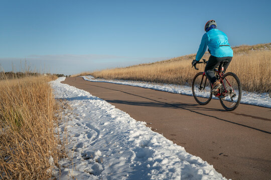 winter afternoon on a biking trail with a male cyclist riding a gravel bike - Cathy Fromme Prairie Natural Area in Fort Collins, Colorado