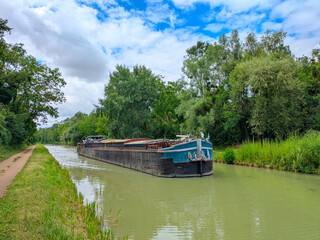 Fototapeta premium long cargo barge canal France