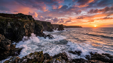 Fototapeta premium dramatic ocean waves crashing against rocky coastline at sunset.