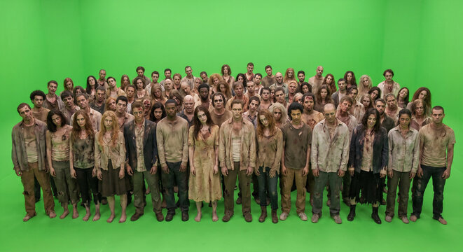 Large group of diverse people dressed as zombies standing together in a studio 
