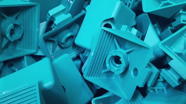 Industrial video with camera panning over turquoise plastic components. Abstract factory background of manufactured polymer details, geometric rows and engineering items.