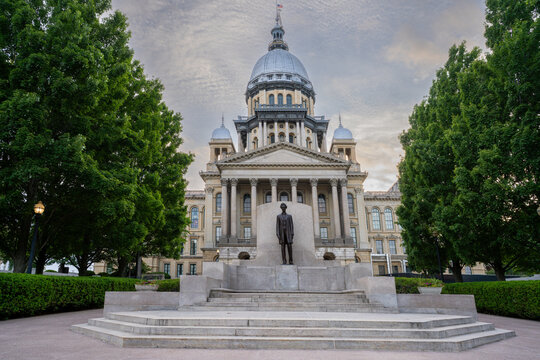 Illinois State Capitol Building with statue just after sunset. Soft clouds drift above classical architectural facade