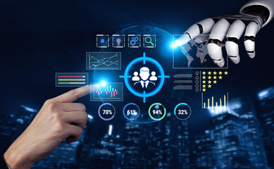 Obraz premium Futuristic Technology Interaction Between Human Hand and Robot Arm Analyzing Data Visualizations and Metrics for Business Intelligence Fluxor.
