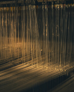 Close-up shot of the yarn and loom detail on the weaving loom.