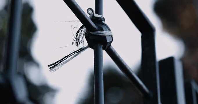 Black and White Cloth Tied to Metal Railing Fluttering in the Wind &ndash; Symbolic Outdoor Scene in 4K 60fps