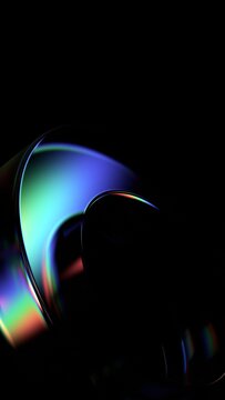 Abstract minimalist glass shape on a black background with color refraction effect, vertical 3d render