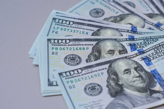 Background of one hundred dollar bills scattered on a flat surface. US cash currency, financial success, business investment budget, tax wealth or international banking economic banner concept.