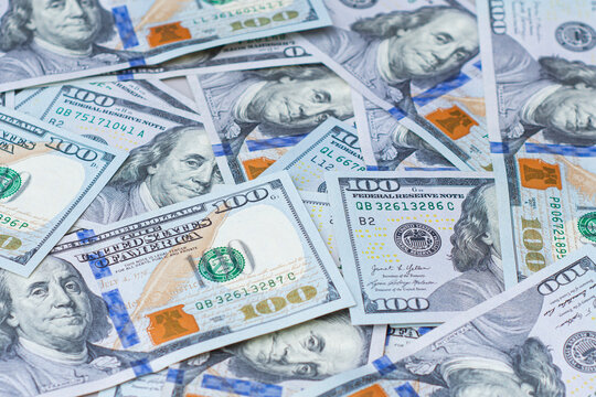 Background of one hundred dollar bills scattered on a flat surface. US cash currency, financial success, business investment budget, tax wealth or international banking economic banner concept.