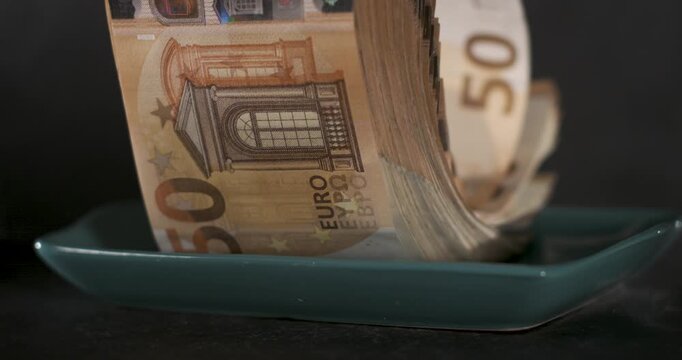Butter dish opening reveals stack of 50 euro banknotes in super slow motion