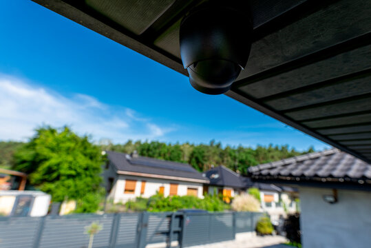 Security dome camera monitoring suburban home property