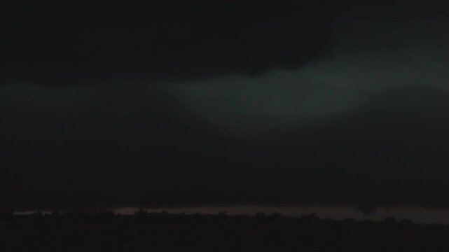 Massive thunderclouds glowing with repeated lightning bursts