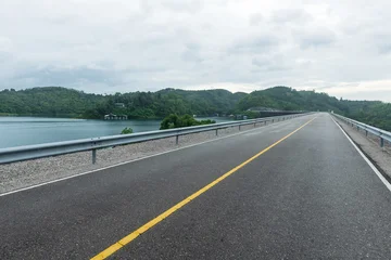 Empty asphalt road in countryside and beautiful natural panoramic countryside landscape with mountains. © yotrakbutda