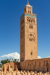 Fototapeta premium Historic Koutoubia Mosque Minaret in the Old Medina of Marrakech Under a Clear Blue Sky