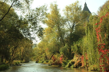Obraz premium Historic Kamianets-Podilskyi Castle rower on a Hill Surrounded by Autumn Forest and River
