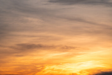 Obraz premium Sky sunset,Beautiful sunrise sky with vibrant gradient orange and gold colors and soft blue, Clear atmosphere with wispy clouds. Peaceful, perfect for background and copy space, High resolution images
