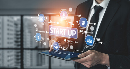 Fototapeta premium A professional businessman engages with a tablet, showcasing startup concepts through a digital interface highlighting growth, innovation, and partnership in a modern workspace. Tessel
