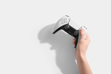 Hand holding modern video game controller on white background © Pixel-Shot