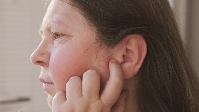 mature woman experiencing agony earache pain, touching ear, ringing and auditory hallucinations, hearing perception, mental health, unusual sounds, sensitivity Tinnitus symptom, sound perception