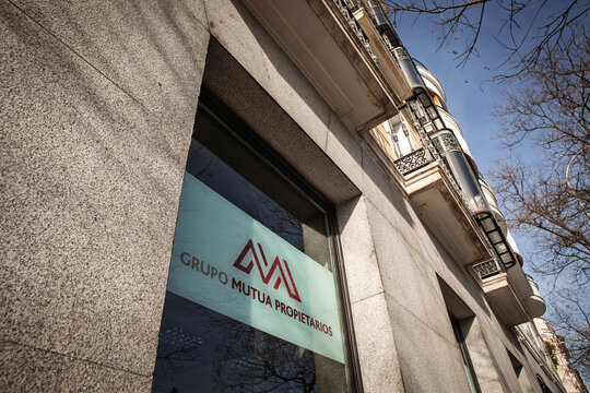 MADRID, SPAIN - FEBRUARY 23, 2026: Grupo Mutua Propietarios logo on an office window and stone facade in madrid. Mutua Propietarios is a Spanish property insurance group.