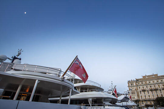 Rijeka, Croatia, Luxury yacht on the Adriatic waterfront flying Cayman Islands colors, a flag of convenience linked to offshore registration, maritime wealth and tax debates in a coastal port setting.