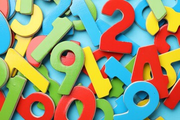 Fototapeta premium Colorful numbers on light blue background, flat lay