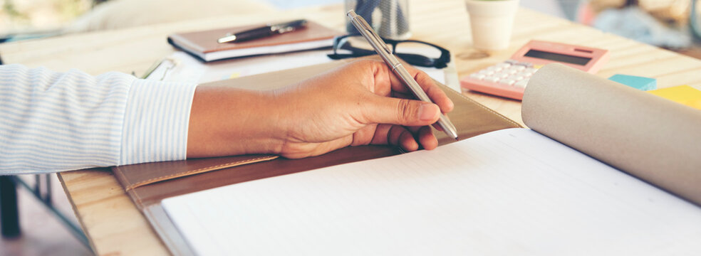 Banner Woman hands pen workspace. Woman hands pen writing notebook. hands pen writing notebook planing meeting excel graph chart. Banner Time management business strategy document with copy space