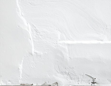 White plastered wall surface, rough textured finish with visible trowel strokes and paint chipping at the bottom, industrial style construction material texture.