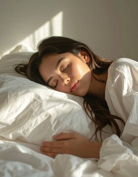 Young woman sleeping peacefully in white bedding, natural sunlight, soft shadows, cozy domestic atmosphere, morning rest, home interior, linen fabric.