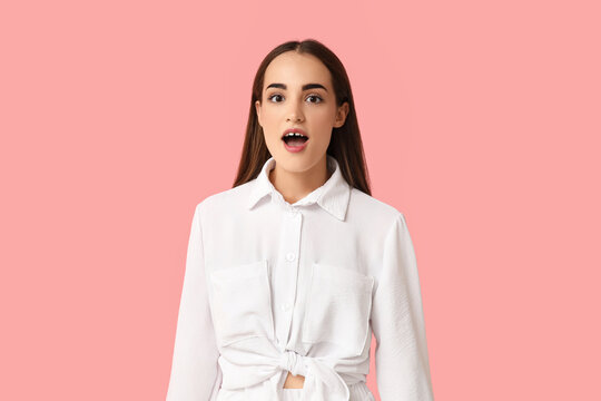 Shocked young woman with diastema on pink background