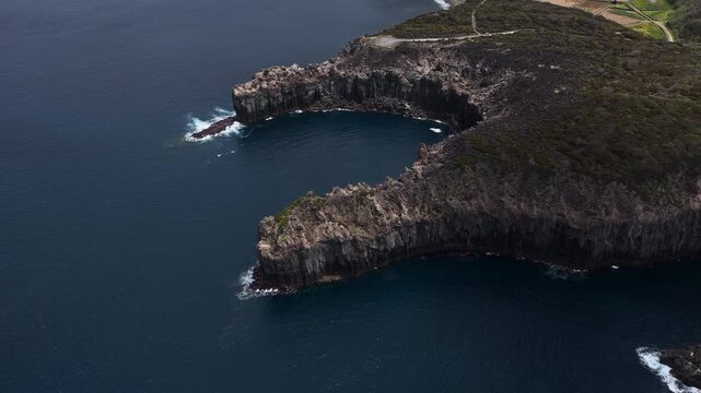 Aerial view of Miradouro de Alagoa, showcasing the rugged volcanic cliffs and deep blue Atlantic waters Agualva, Acores, Portugal.