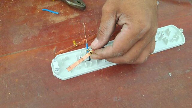 Technician drilling wooden library table with power drill for electrical outlet installation. Worker assembling socket wiring. Construction stock video 4K for DIY, renovation, carpentry, maintenance, 