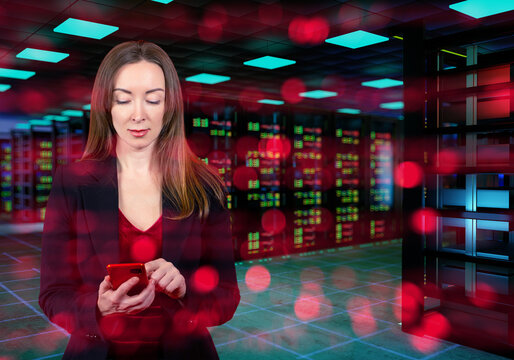 Information technology, businesswoman uses smartphone in data center with server racks and digital network lights