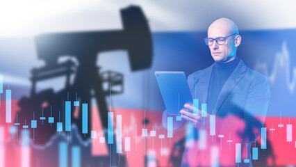 Oil industry, analyst uses tablet with oil pump silhouette and market chart against Russian flag...