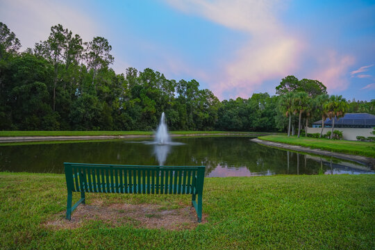  a florida community pond with sunset and colorful cloud