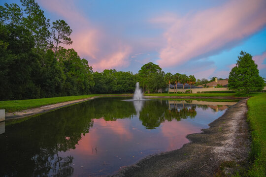  a florida community pond with sunset and colorful cloud