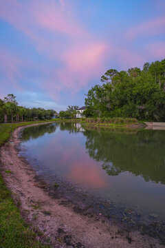  a florida community pond with sunset and colorful cloud