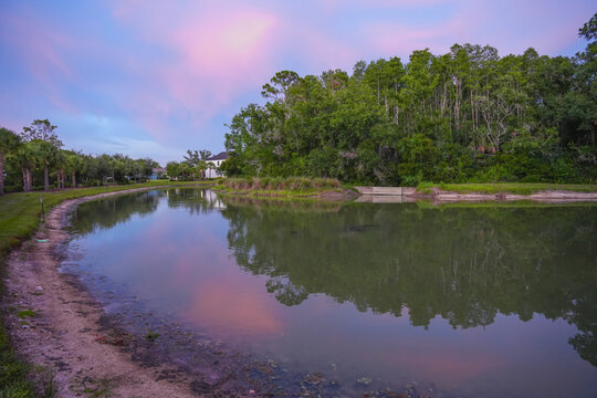  a florida community pond with sunset and colorful cloud