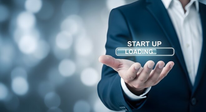 Business start up concept hand holding 'start up loading' digital interface